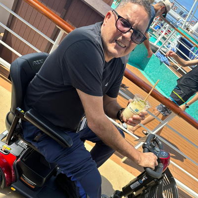 wheelchair user with drink on a cruise